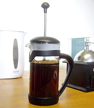 The French Press is filled with hot water and beans